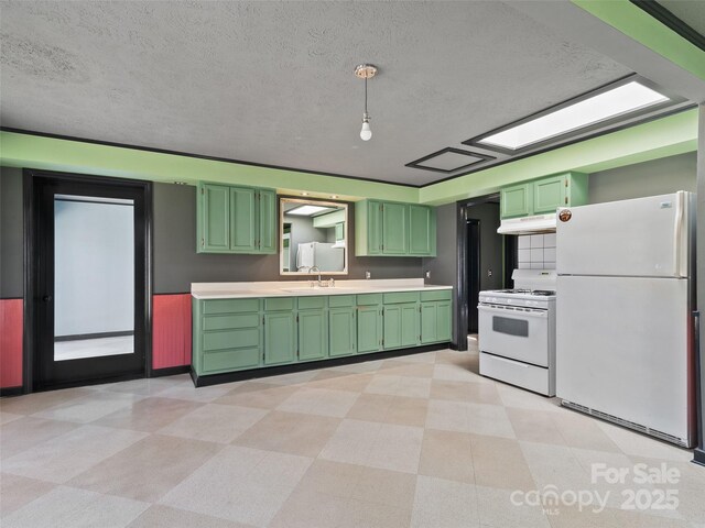 195 Nature Ln, Waynesville, NC 28786 - kitchen featuring light countertops, green cabinets, light floors, under cabinet range hood, and white appliances