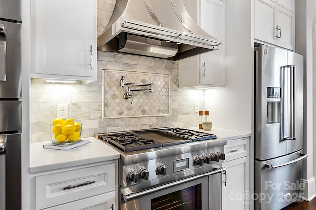 1311 Sunnys Halo Ln, Waxhaw, NC 28173 - kitchen with premium appliances, wall chimney range hood, light countertops, and white cabinetry
