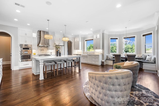 1311 Sunnys Halo Ln, Waxhaw, NC 28173 - living area with arched walkways, crown molding, dark wood-style floors, and recessed lighting