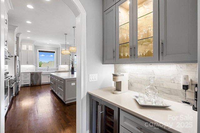 1311 Sunnys Halo Ln, Waxhaw, NC 28173 - bar area featuring stainless steel dishwasher, arched walkways, dark wood-style flooring, backsplash, and beverage cooler