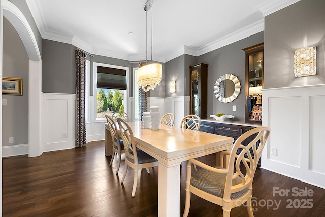 1311 Sunnys Halo Ln, Waxhaw, NC 28173 - dining area with a decorative wall, a chandelier, dark wood finished floors, a wainscoted wall, and ornamental molding