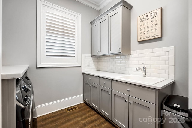 1311 Sunnys Halo Ln, Waxhaw, NC 28173 - washroom with cabinet space, washer and dryer, ornamental molding, and dark wood-style flooring