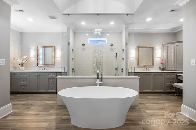 1311 Sunnys Halo Ln, Waxhaw, NC 28173 - full bath with a shower stall, a freestanding tub, two vanities, recessed lighting, and crown molding