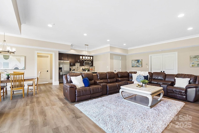 1311 Sunnys Halo Ln, Waxhaw, NC 28173 - living room featuring a chandelier, light wood finished floors, recessed lighting, and ornamental molding