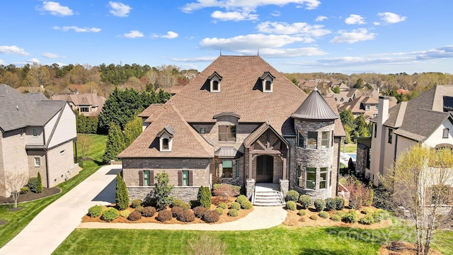 1311 Sunnys Halo Ln, Waxhaw, NC 28173 - french country home featuring stone siding, a standing seam roof, a metal roof, a residential view, and concrete driveway