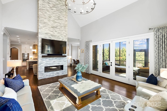 1311 Sunnys Halo Ln, Waxhaw, NC 28173 - living area featuring high vaulted ceiling, hardwood / wood-style floors, french doors, a fireplace, and a chandelier