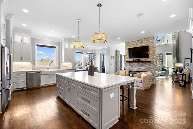 1311 Sunnys Halo Ln, Waxhaw, NC 28173 - kitchen featuring stainless steel appliances, open floor plan, a breakfast bar, a center island, and backsplash