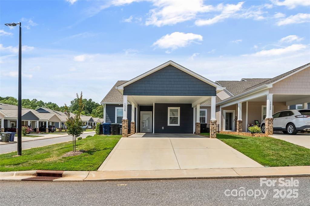 1528 28th Street Pl SE, Hickory, NC 28602 - view of front facade with driveway, a front yard, and an attached carport