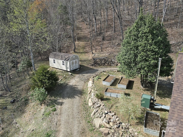 view of property location with a forest