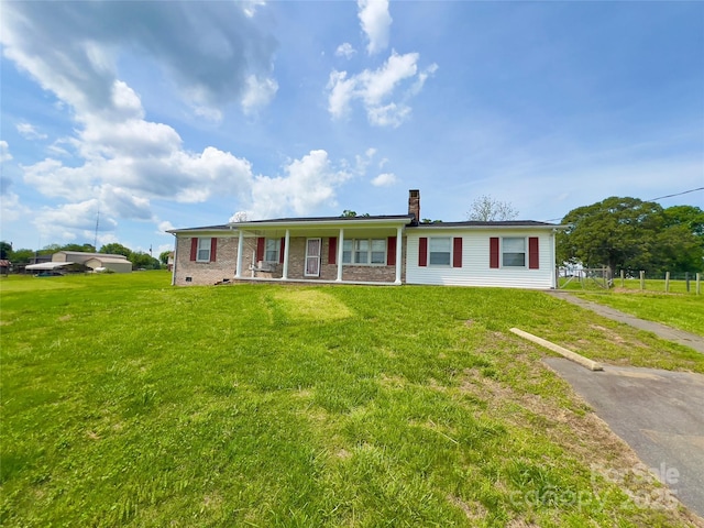 2025 Baton School Rd, Lenoir, NC 28645 - ranch-style house with covered porch, fence, a chimney, and a front yard