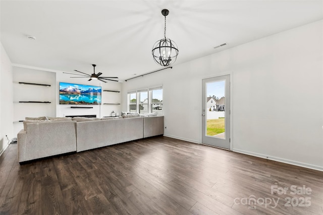 unfurnished living room with baseboards, visible vents, ceiling fan with notable chandelier, and dark wood-type flooring