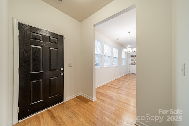 9001 Lanark Ln, Indian Land, SC 29707 - entrance foyer featuring light wood-style floors, a chandelier, and baseboards