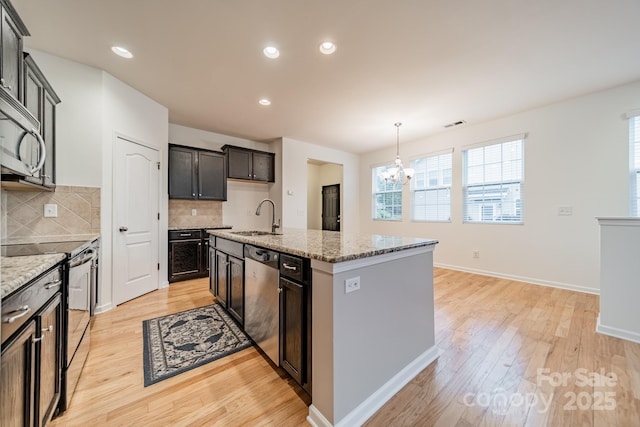 9001 Lanark Ln, Indian Land, SC 29707 - kitchen featuring stainless steel appliances, a sink, a chandelier, light wood finished floors, and recessed lighting