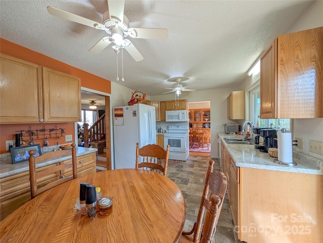 dining room with a textured ceiling, stairway, and ceiling fan