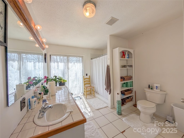 full bath with vanity, toilet, tile patterned floors, visible vents, and curtained shower