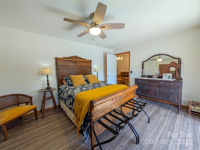 bedroom with a ceiling fan, wood finished floors, and a textured ceiling