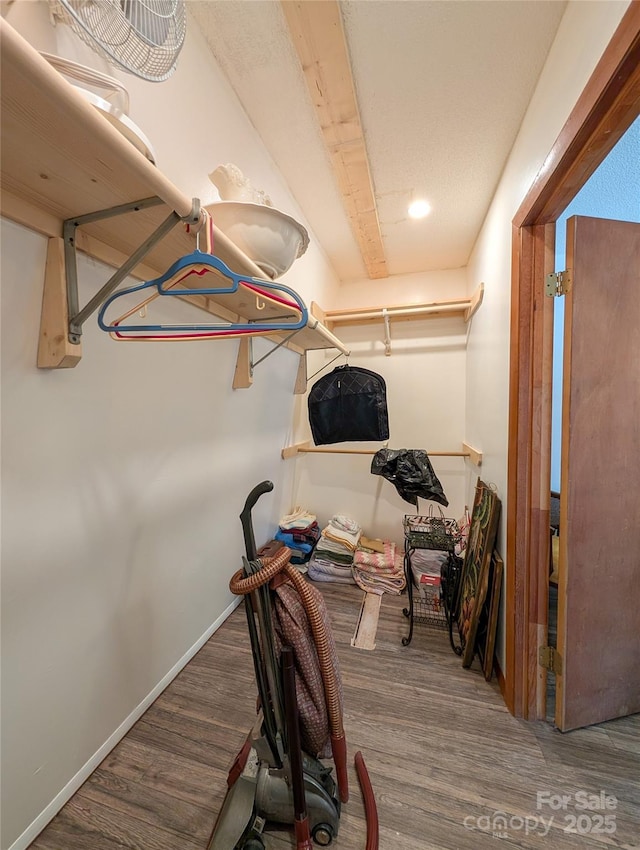 interior space with baseboards and wood finished floors