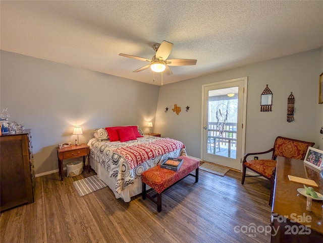 bedroom featuring a textured ceiling, baseboards, ceiling fan, and wood finished floors