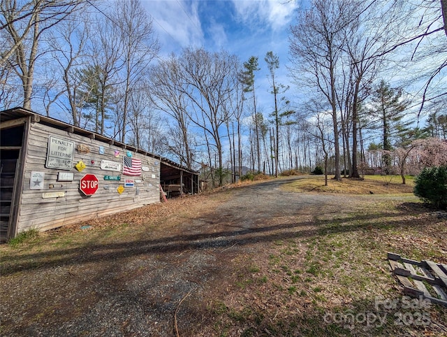exterior space featuring dirt driveway
