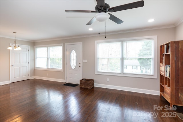 2408 Dora Dr, Charlotte, NC 28215 - entrance foyer with dark wood-style flooring, baseboards, ornamental molding, ceiling fan, and a chandelier