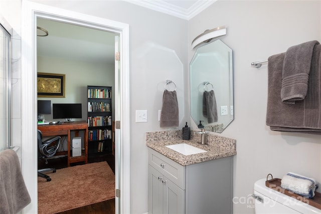 2408 Dora Dr, Charlotte, NC 28215 - bathroom featuring ornamental molding, vanity, toilet, and wood finished floors