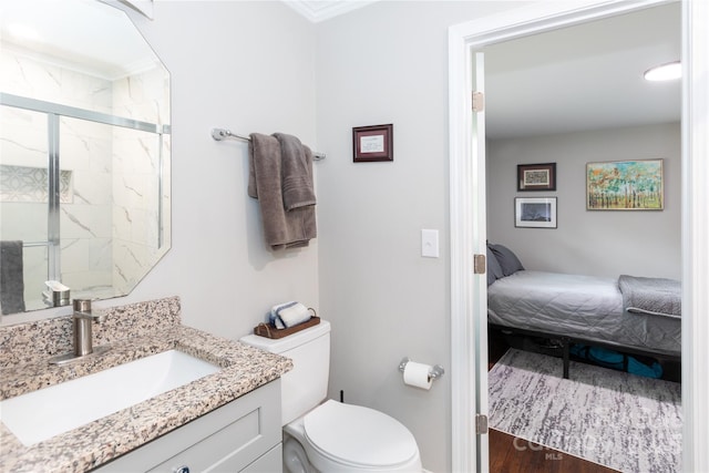 2408 Dora Dr, Charlotte, NC 28215 - ensuite bathroom with toilet, a stall shower, vanity, and wood finished floors