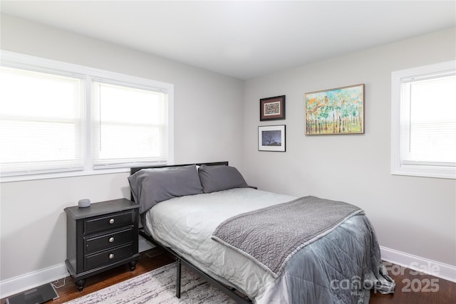 2408 Dora Dr, Charlotte, NC 28215 - bedroom with multiple windows, dark wood-style flooring, and baseboards