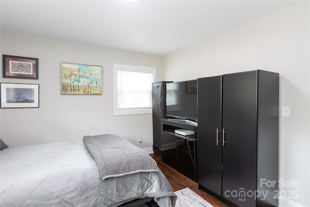 2408 Dora Dr, Charlotte, NC 28215 - bedroom with dark wood finished floors and baseboards