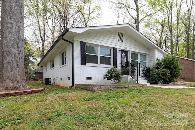 2408 Dora Dr, Charlotte, NC 28215 - view of front facade with crawl space, central AC unit, brick siding, and a front yard