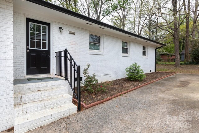 2408 Dora Dr, Charlotte, NC 28215 - property entrance with crawl space and brick siding