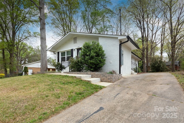 2408 Dora Dr, Charlotte, NC 28215 - view of front of house featuring a front yard, brick siding, and concrete driveway
