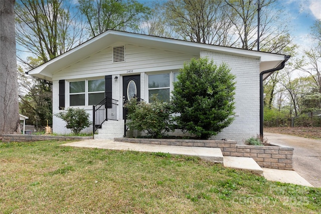 2408 Dora Dr, Charlotte, NC 28215 - view of front facade featuring brick siding and a front yard