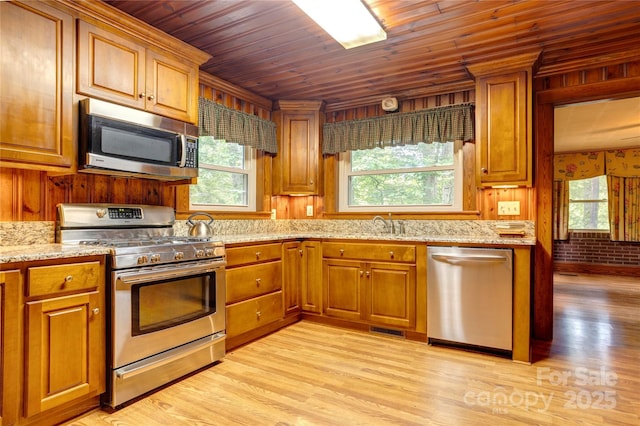 235 John Rainey Rd, Salisbury, NC 28147 - kitchen with stainless steel appliances, plenty of natural light, brown cabinets, and wood ceiling