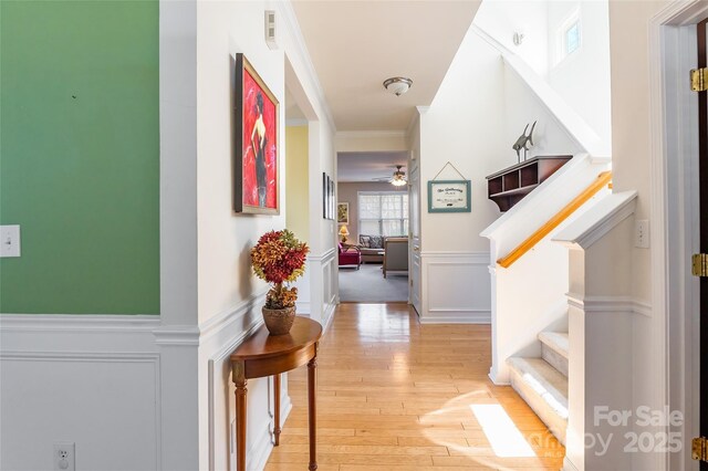 7554 Coastal Way, Huntersville, NC 28078 - hallway with a wainscoted wall, light wood-style flooring, a decorative wall, visible vents, and ornamental molding
