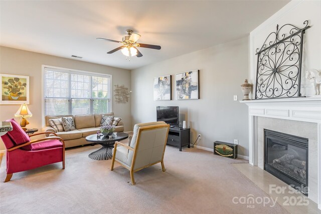 7554 Coastal Way, Huntersville, NC 28078 - living room with a premium fireplace, baseboards, light colored carpet, visible vents, and ceiling fan