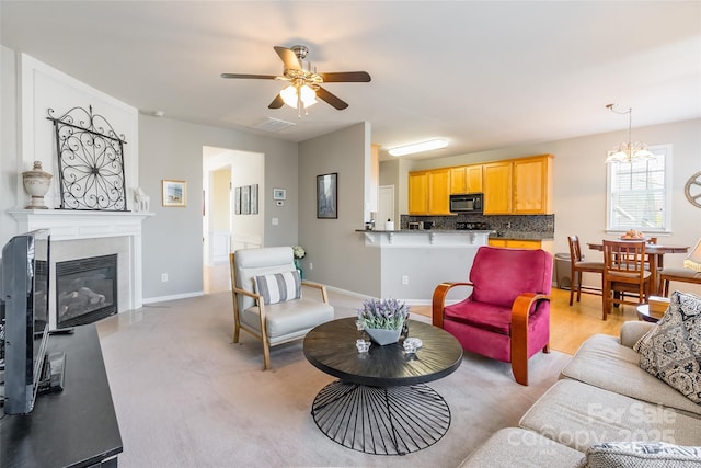 7554 Coastal Way, Huntersville, NC 28078 - living area featuring a fireplace with flush hearth, ceiling fan with notable chandelier, baseboards, and visible vents