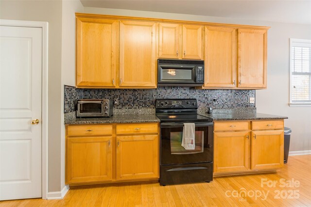 7554 Coastal Way, Huntersville, NC 28078 - kitchen with decorative backsplash, dark stone countertops, black appliances, and a toaster