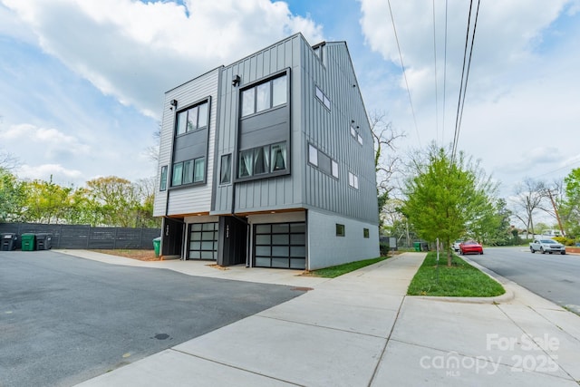 exterior space with an attached garage and fence