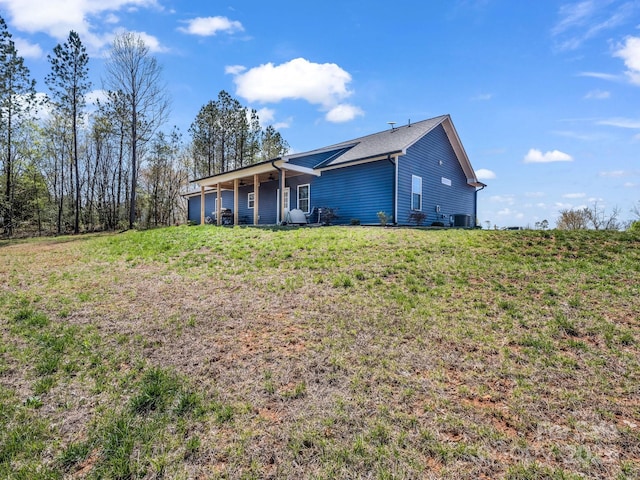 back of property featuring a yard and central AC unit