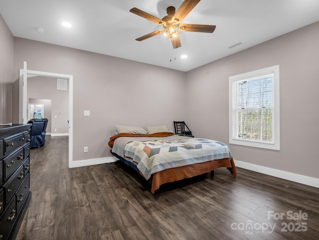 bedroom featuring baseboards, visible vents, and dark wood-style floors