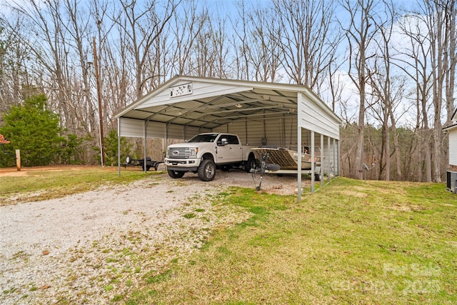 view of car parking with a detached carport and dirt driveway
