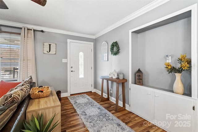 foyer entrance with a wealth of natural light, crown molding, wood finished floors, and baseboards