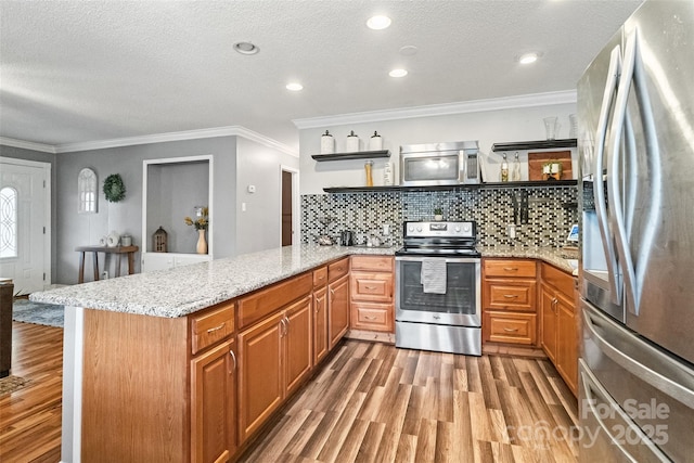 kitchen featuring open shelves, light wood finished floors, tasteful backsplash, appliances with stainless steel finishes, and a peninsula