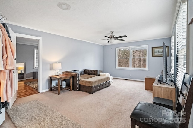 interior space featuring a ceiling fan, ornamental molding, and baseboards