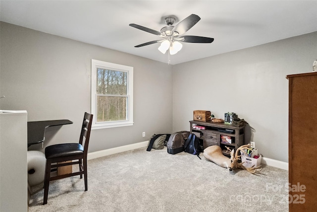 interior space with baseboards, carpet floors, and ceiling fan