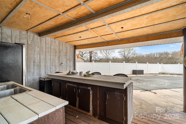 kitchen featuring light countertops, a sink, and freestanding refrigerator
