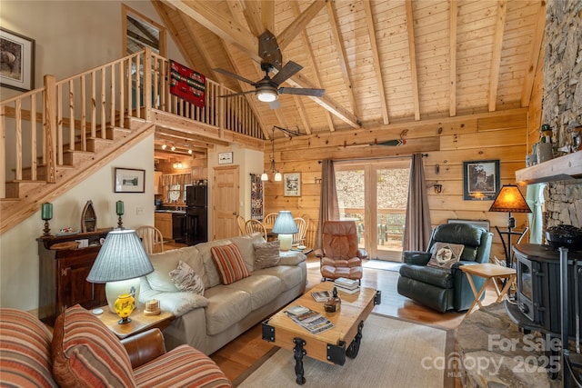 living area with wood ceiling, wood finished floors, beam ceiling, and stairway