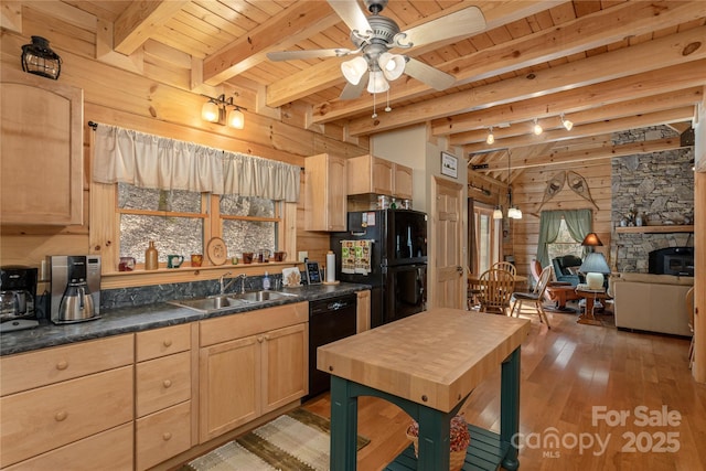 kitchen with wooden ceiling, light brown cabinets, a sink, wood walls, and black appliances