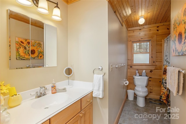 bathroom featuring baseboards, wooden ceiling, toilet, vanity, and tile patterned floors