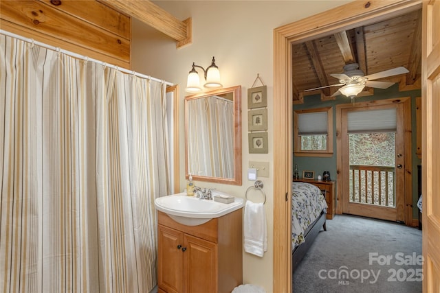 bathroom featuring connected bathroom, vanity, a ceiling fan, wood ceiling, and vaulted ceiling with beams